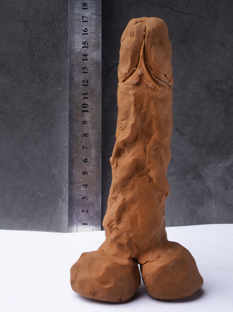 symbol of men penis and measurement tape. Men penis size concept. Studio shot isolated on grey...