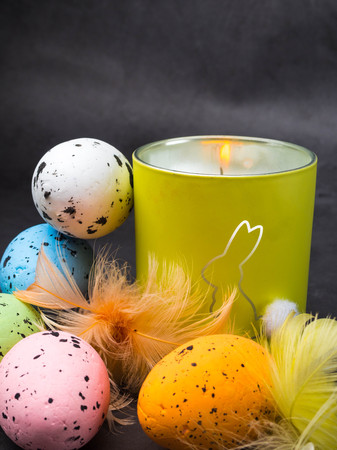Easter decoration. decorative bunny figure on candl, card with greeting Happy Easter on grey...