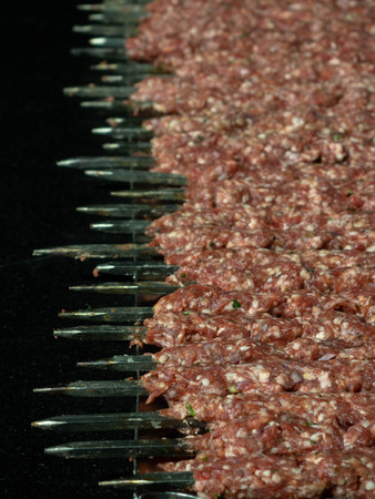 delicious bbq kebab grilling on open grill, outdoor kitchen. food festival in city. tasty food roasting on skewers, food-court. summer picnicの写真素材