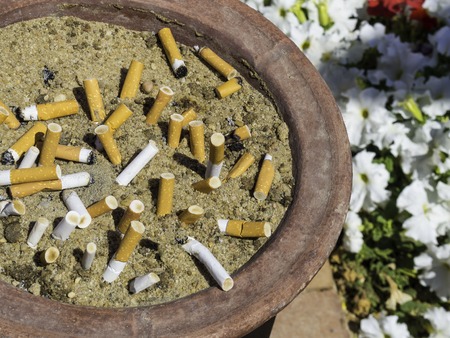 Smoked Cigarettes in the sand ashtray, Stop smoking Concept, unhealthy