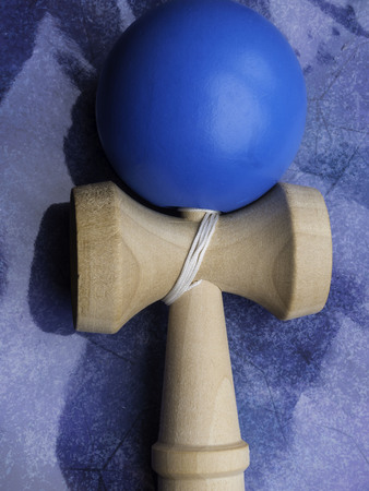 Kendama Japanese toy with free space for text, glossy blue backgroundの写真素材