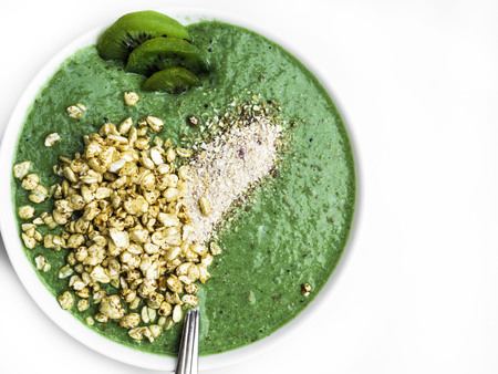 Healthy smoothie for breakfast, kiwi, chia, flakes and green vegetables, leafsの写真素材