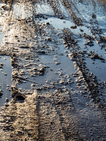 dirty rural road with deep tire tracks, bad road conceptの写真素材
