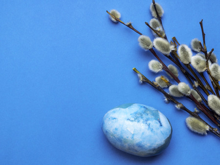 pussy-willow twigs with Easter eggs isolated on blue, copy spaceの写真素材