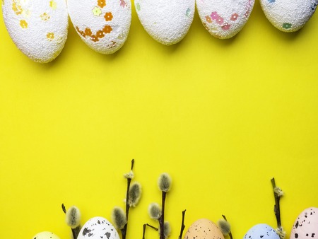 pussy-willow twigs with Easter eggs isolated on yellowの写真素材