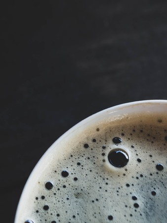 Cup of fresh coffee on old wooden background, top view, copy spaceの写真素材