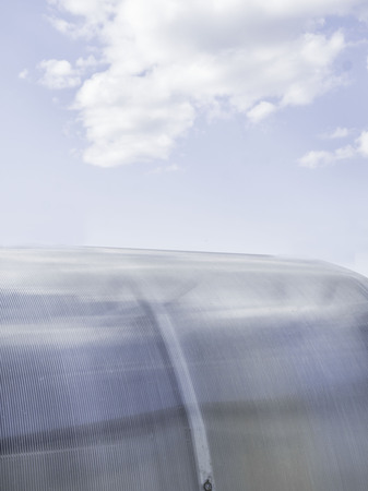 Polycarbonate sheeting as a part of modern greenhouse construction, roof of polycarbonate against the skyの写真素材