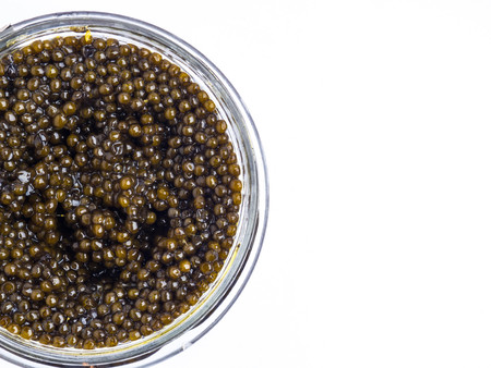 Black caviar in a little bowl on a white backgroundの写真素材