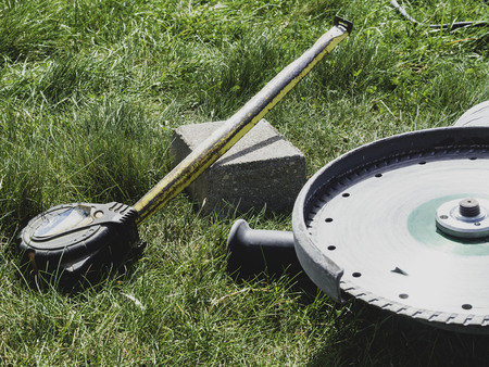 pavement Stone are laying on grass. Work tools, measure ruler and saw on grassの写真素材
