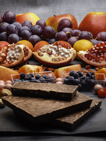 Composition with fruits nuts blueberry, cranberry, chocolate, resveratrol, antioxidants rich food, Healthy food conceptの写真素材