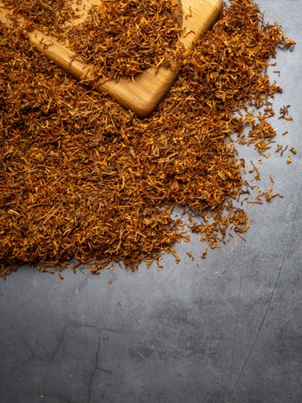 Dry tobacco leaves. High quality tobacco on wooden board close up, backgroundの写真素材