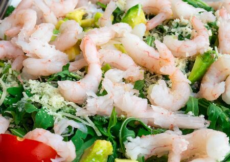 Fresh salad plate with shrimp, tomato and mixed greens arugula, mesclun, mache on wooden background close up. Healthy food. Clean eating.の写真素材