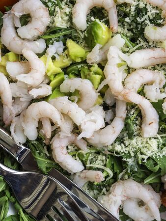Fresh salad plate with shrimp, tomato and mixed greens arugula, mesclun, mache on wooden background close up. Healthy food. Clean eating.の写真素材