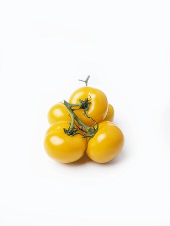 Fresh yellow tomatoes on white  with copy spaceの写真素材