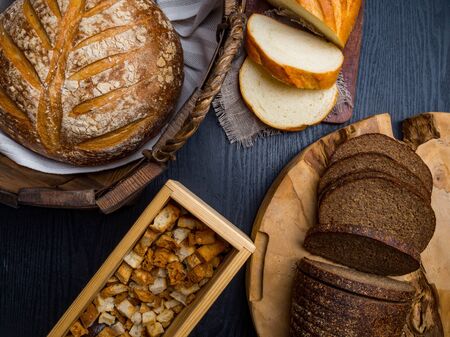 Several types of fresh breads, crackers lying on an wooden tableの写真素材