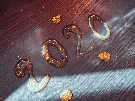 Happy New Year 2020. Number 2020 written sparkling sparklers isolated on black background With Copy...