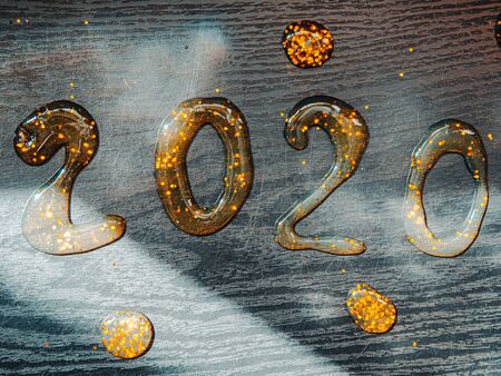 Happy New Year 2020. Number 2020 written sparkling sparklers isolated on black background With Copy Space For Text. Beautiful Glowing overlay template for holiday greeting card.の写真素材