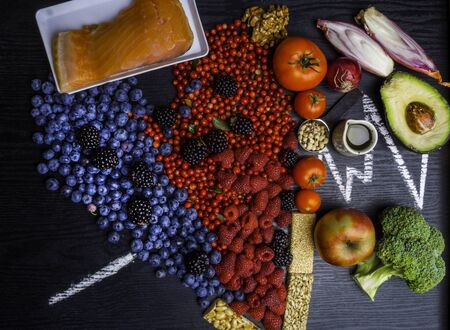 Healthy eating and heart health concept with a heart shaped with blueberries, raspberries,...