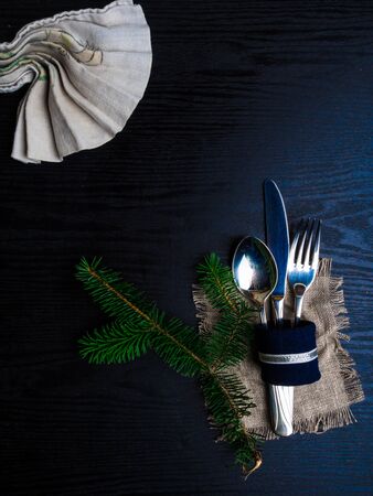 Christmas table setting in silver tone on wooden table