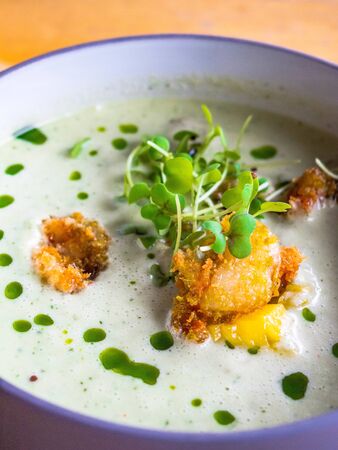Thailand tradition green curry soup with shrimps prawns and coconut milk. Green Curry in violet bowl...