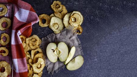 fresh applewith pieces of dry in dehydrator slices of yellow and red apples, healthy snack conceptの写真素材