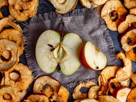 fresh applewith pieces of dry in dehydrator slices of yellow and red apples, healthy snack conceptの写真素材