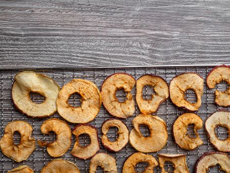 dehydrated tasty apple fruit slices in metal tray, close upの写真素材