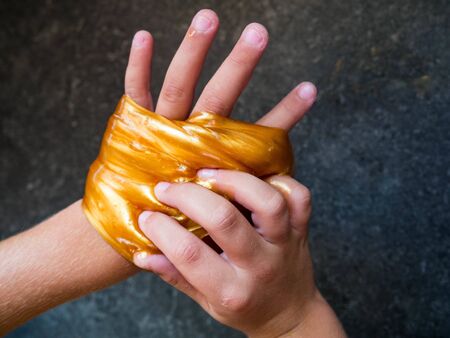Kid Playing Hand Made Toy Called Slimeの写真素材