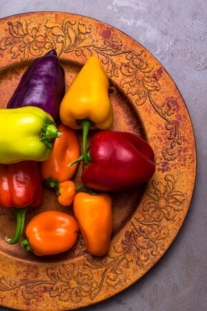 colorful sweet bell peppers paprika on golden plateの写真素材