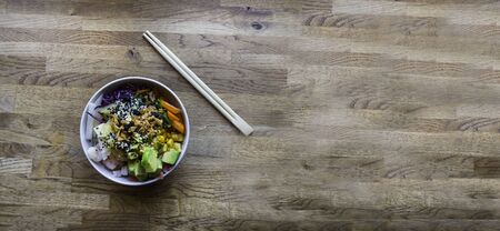 banner of Traditional Hawaiian poke seafood dish with wooden sticksの写真素材