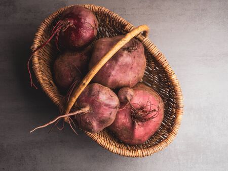 Fresh organic beetroot in a wicker basket, toned, close up