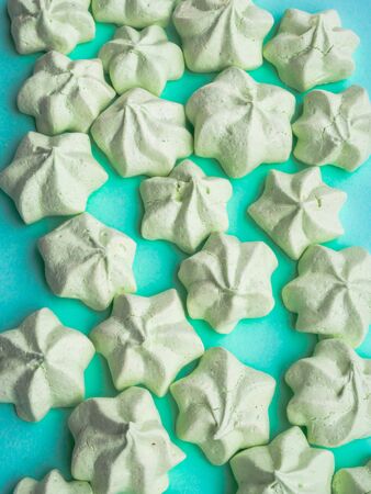 mint green sweet meringues over pastel mint backdrop with copy spaceの写真素材