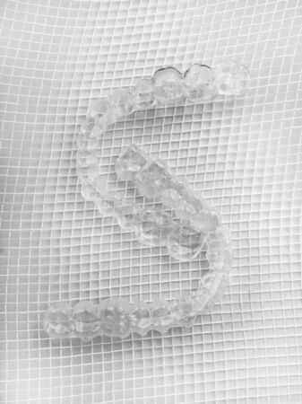 orthodontic clear aligner to straighten teeth on white background