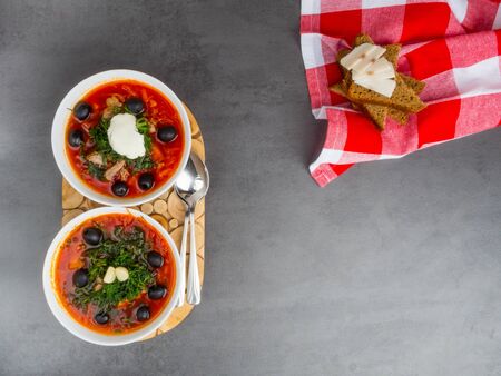Traditional Ukrainian Russian borscht with olives, dill, garlic, lard on the bowls. Beetroot soup...