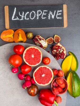 Fruits and vegetables containing lycopene. Healthy vegan food background. Lycopene is a red...