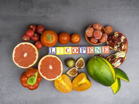 Fruits and vegetables containing lycopene. Healthy vegan food background. Lycopene is a red...