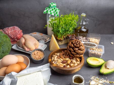 Healthy Diet - foods that are a rich source of proteins, includes meat, fish, shrimps, cheese, eggs, milk, nuts, avocado, greenery, beans seeds oil oat copy spaceの写真素材