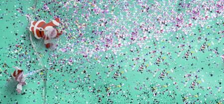 Christmas background with decorations, Santa claus and colorful confetti on green mint background. Christmas trendy composition.の写真素材