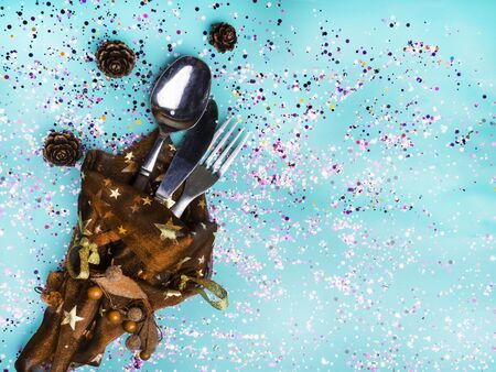 Decorated Christmas Dinner Table Setting, with cone, decorative berries, confetti, golden starsの写真素材