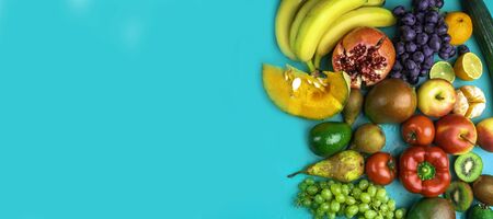 Fruits rich in antioxidants, vitamin and fiber on blue background. Flat lay style. Raw, vegan, vegetarian, alkaline food concept. Copy spaceの写真素材