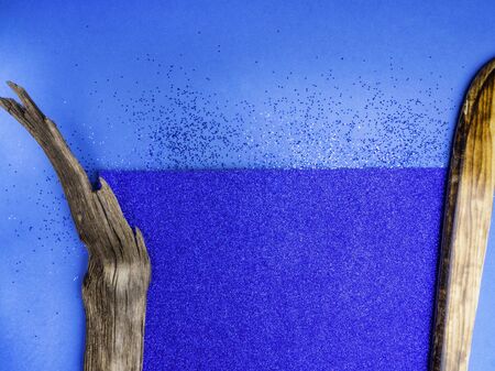 Blue shiny cardboard background, and wooden decorative elements, trendy color of 2020 yearの写真素材