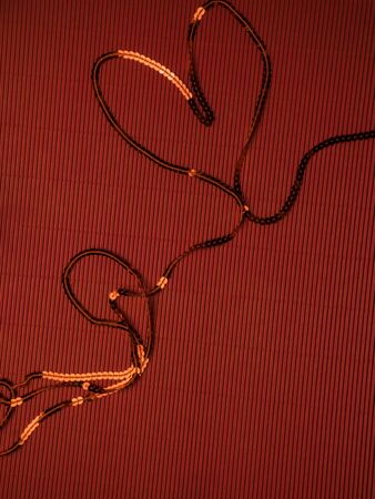 Sparkly sequined red festive background, Shaped sequin decorations. Christmas. Valentine day. Wedding. Birthday. Flat lay, top view, copy space, postcardの写真素材