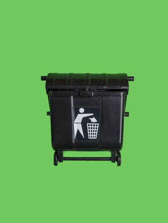 Black trash toy can or recycle bin isolated on green, close upの写真素材