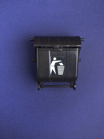 Black trash toy can or recycling bin or recycle bin on trendy blue backgroundの写真素材