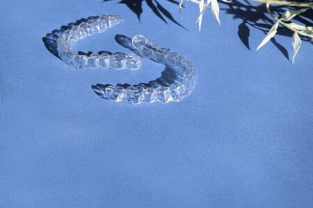 Modern tooth transparent aligners or braces to straighten teeth in cosmetic dentistry and...