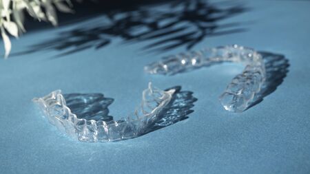 Modern tooth transparent aligners or braces to straighten teeth in cosmetic dentistry and...