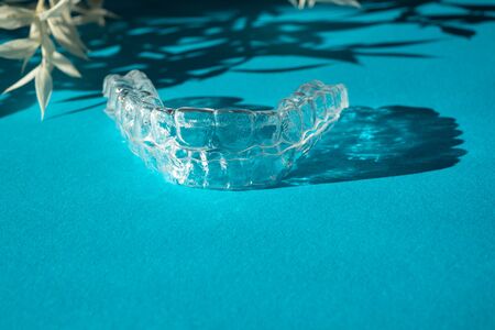 Modern tooth transparent aligners or braces to straighten teeth in cosmetic dentistry and...