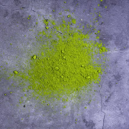Heap of japanese matcha green tea powder on concrete background, top-view, close-up. Above