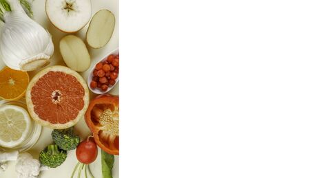 Healthy diet, fresh colorful sources of Vitamin C and antioxidants, food clean eating colorful selection, as grapefruit, lemon, apple, orange, bell pepper slices, fennel, potatoes, cranberries, broccoli, copy spaceの写真素材