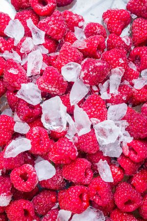 fresh organic raspberries background with ice, close upの写真素材